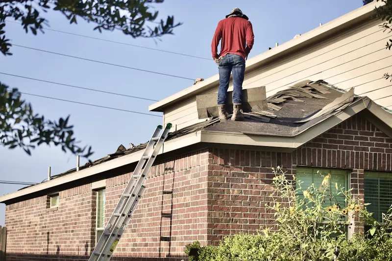 Professional roofer working on a residential roof in League City